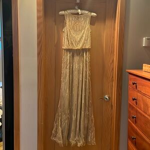 Champagne slip dress w/ sheer overlay adorned with sequins, crystals and beads.